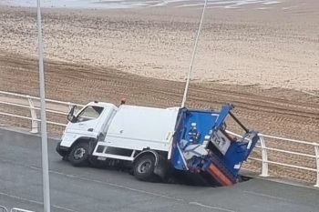 Sinkhole swallows up bin lorry image